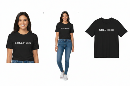 Black t-shirt with 'STILL HERE' text worn by a model on a white background