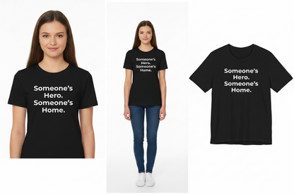 Black t-shirt with 'Someone's Hero. Someone's Home.' text worn by a person on a white background