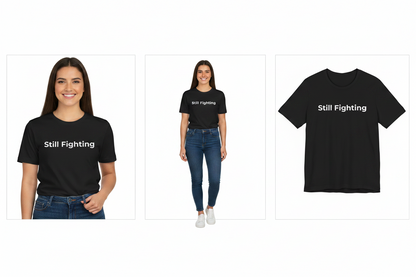Black t-shirt with 'Still Fighting' text worn by a person on a white background