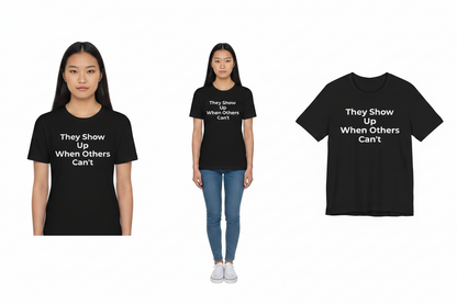 Black t-shirt with 'They Show Up When Others Can't' text worn by a person on a white background