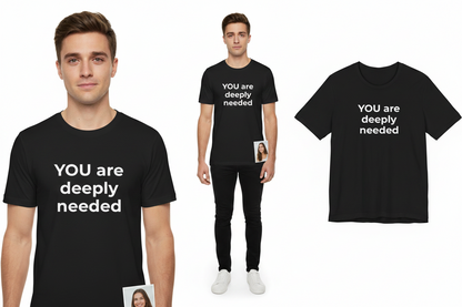 Black t-shirt with 'YOU are deeply needed' text worn by a person on a white background