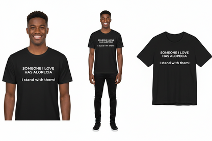 Black t-shirt with text 'Someone I love has alopecia. I stand with them!' worn by a person, displayed on a white background.