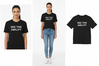 Person wearing a black t-shirt with 'See the Ability' text, standing next to a plain white background.