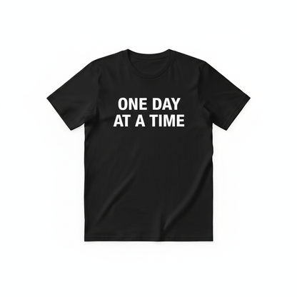 Flat lay black One Day at a Time shirt